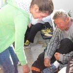 Casa Esperanza: man putting on a shoe with assistance