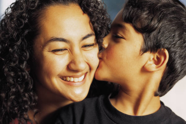 Domestic Violence Solutions: Son kissing happy mother