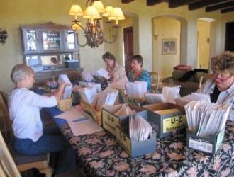 Volunteers gather to distribute a mailing